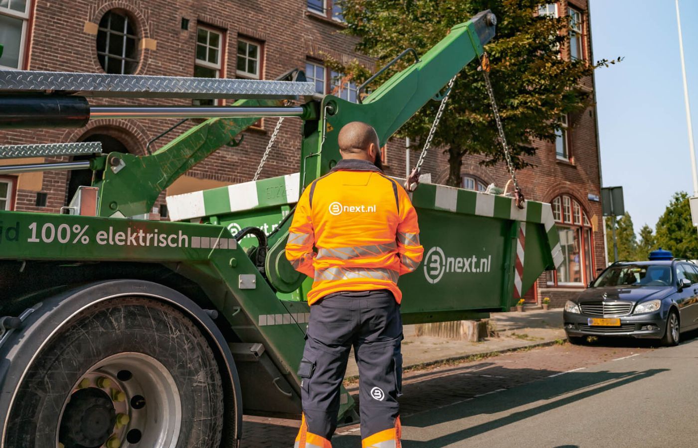 Bnext medewerker zet een container af in een stadsstraat